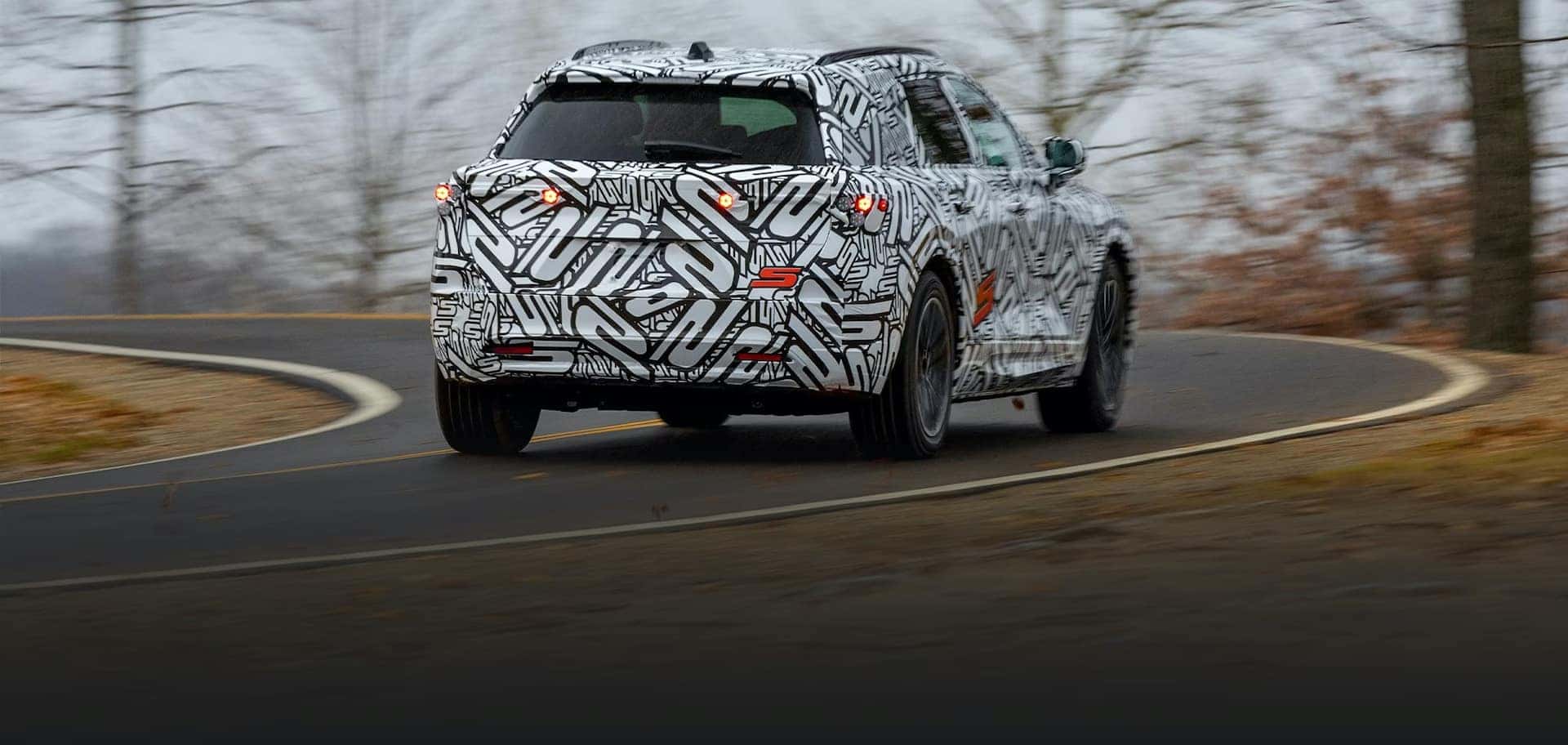 2024 Acura ZDX driving on curvy road.