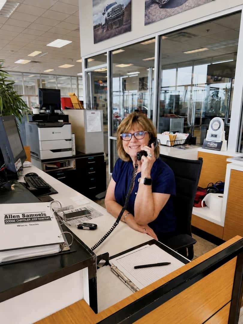 Allen Samuels receptionist answering the phone at the dealership front desk