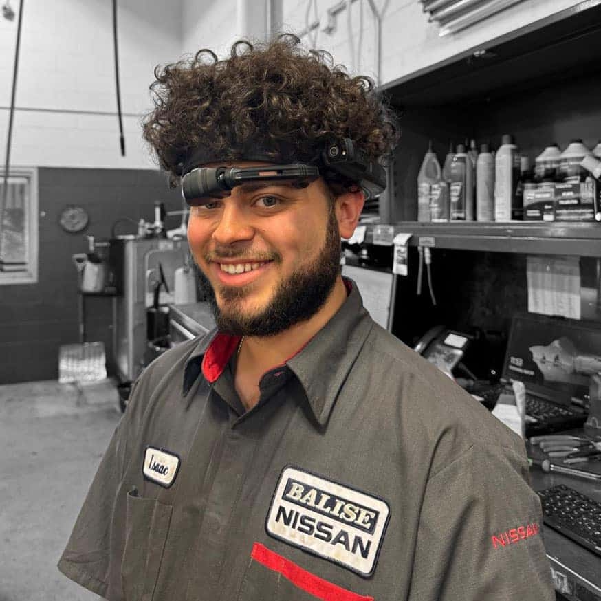 Nissan service technician wearing LenZ headset while facing the camera