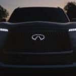 A close-up of the 2025 INFINITI QX80's LED headlights shining
