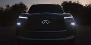 A close-up of the 2025 Infiniti QX80's LED headlights shining