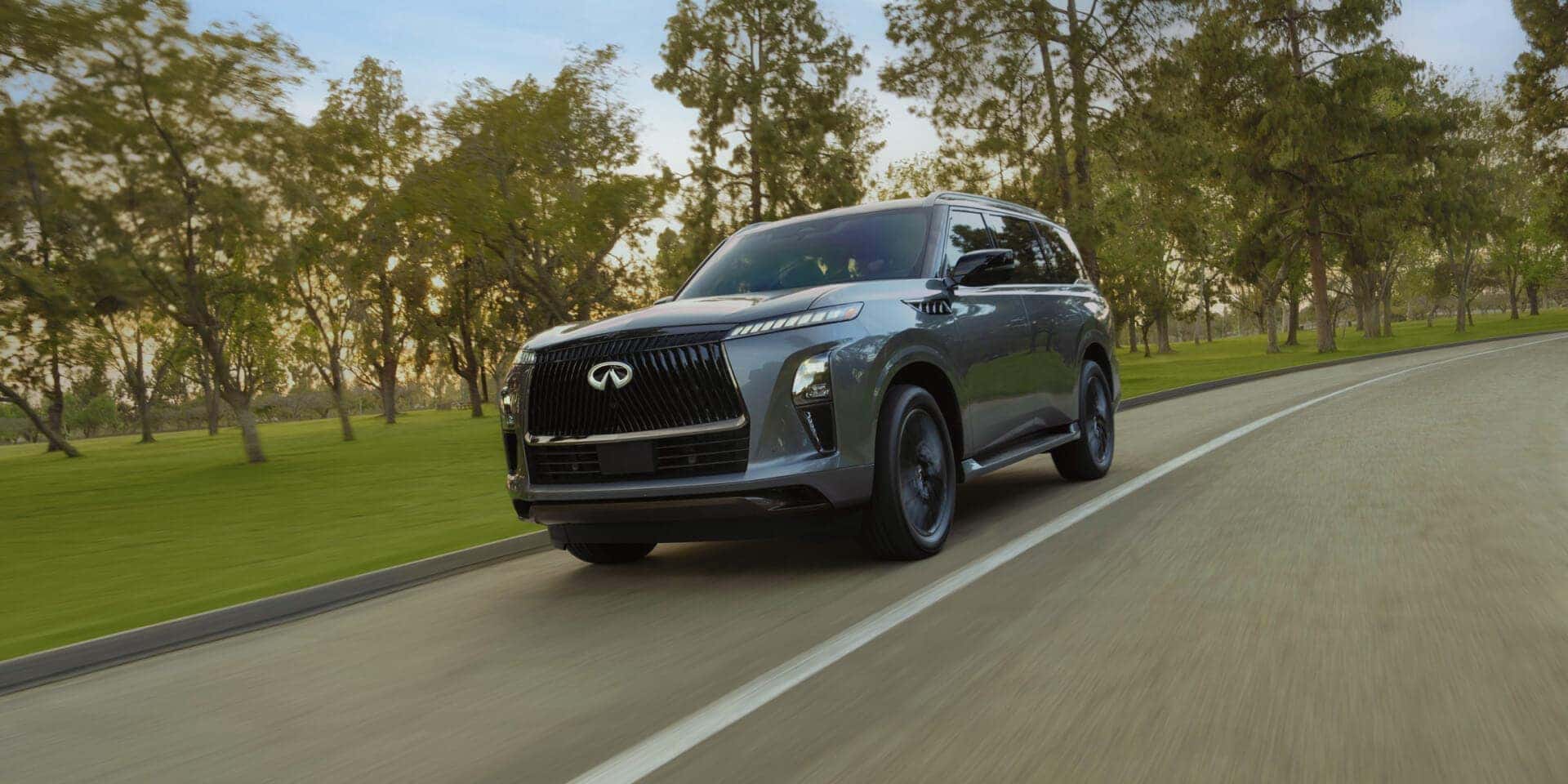 A gray 2026 INFINITI QX80 driving on the road