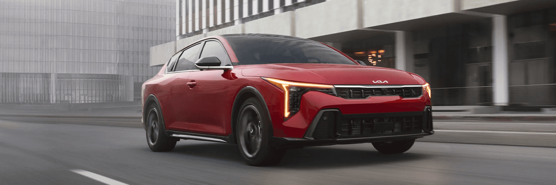 Red 2026 Kia K4 driving
