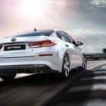 2019 Kia Optima S in white racing down track