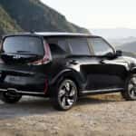 A Black Kia Soul parked overlooking the mountains.
