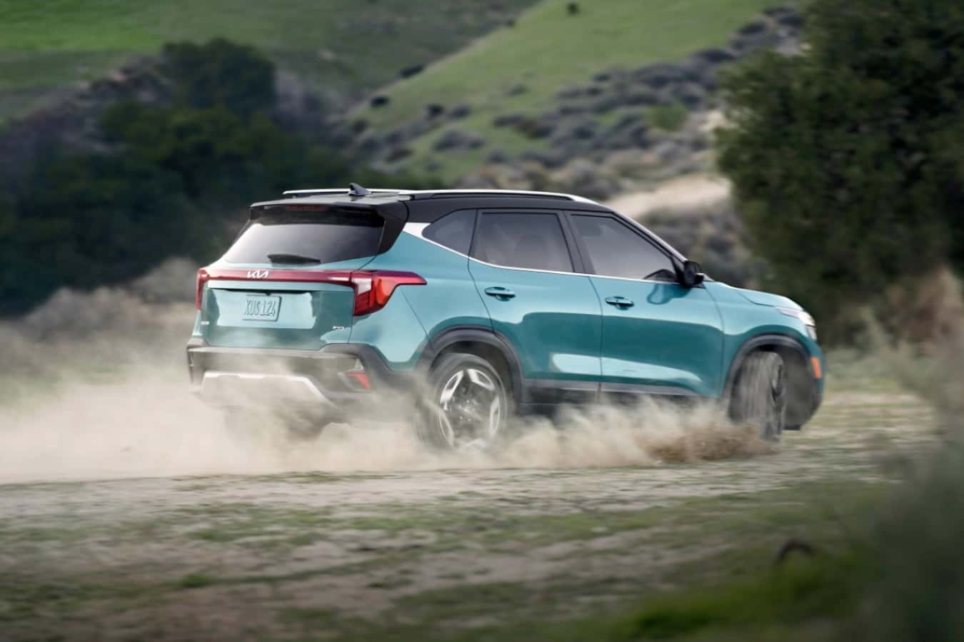 BLUE KIA Seltos kicking up dirt