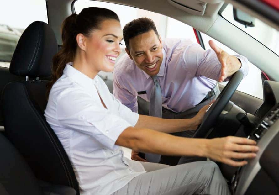 friendly car salesman helping a customer