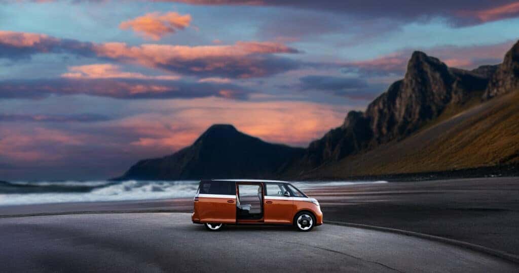 2025 Volkswagen ID Buzz parked at the beach at sunset with both side doors slid open