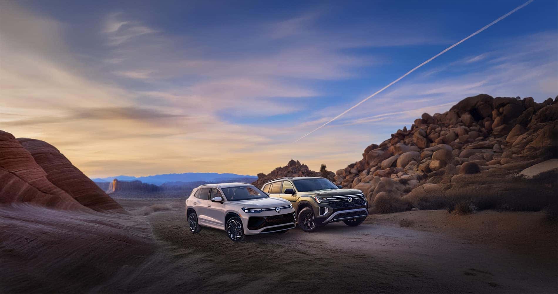 Volkswagen Atlas vs Tiguan parked next to eachother in the desert at sunset