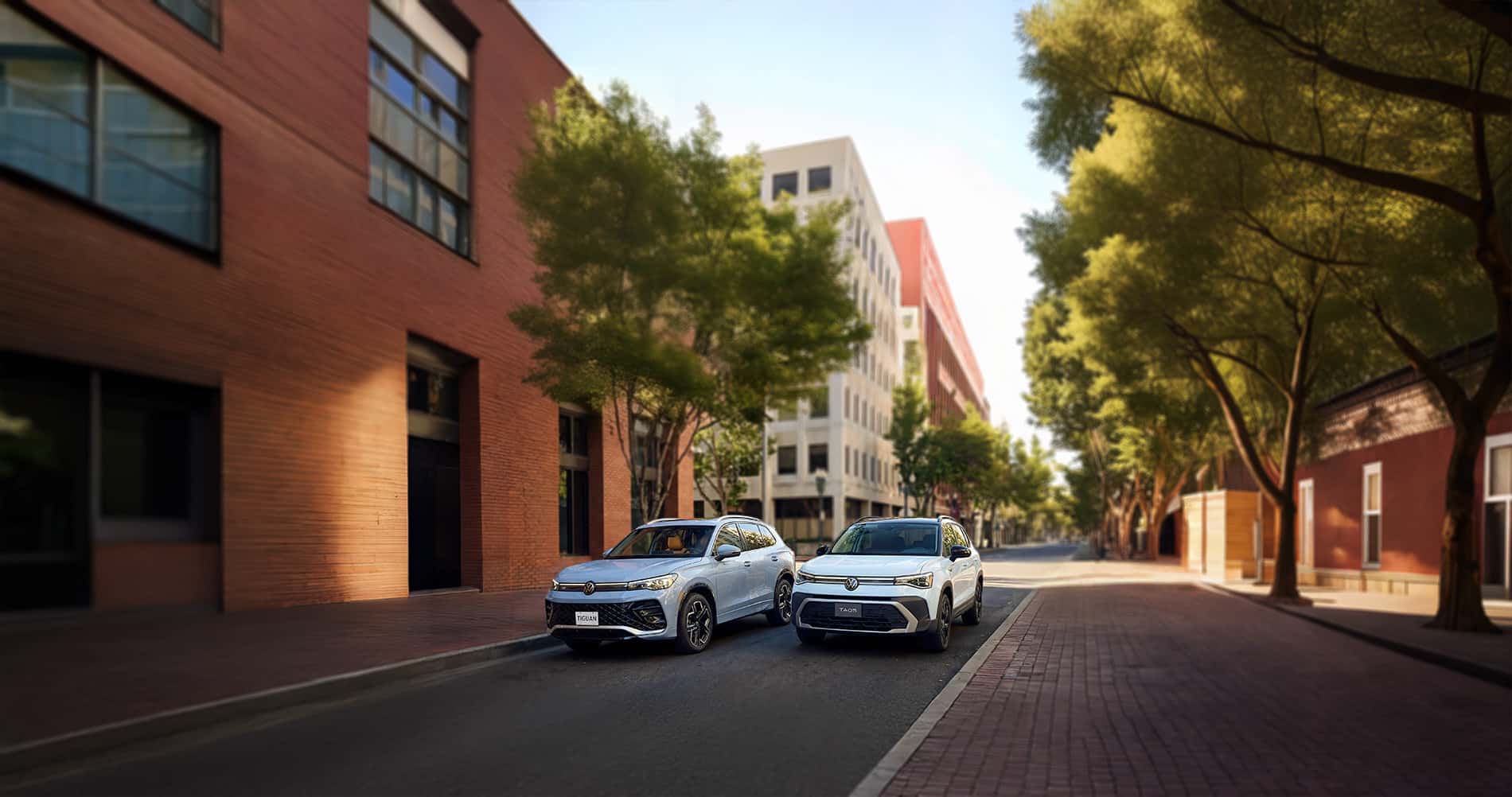 2026 Volkswagen Taos vs Tiguan parked in a city downtown during the day