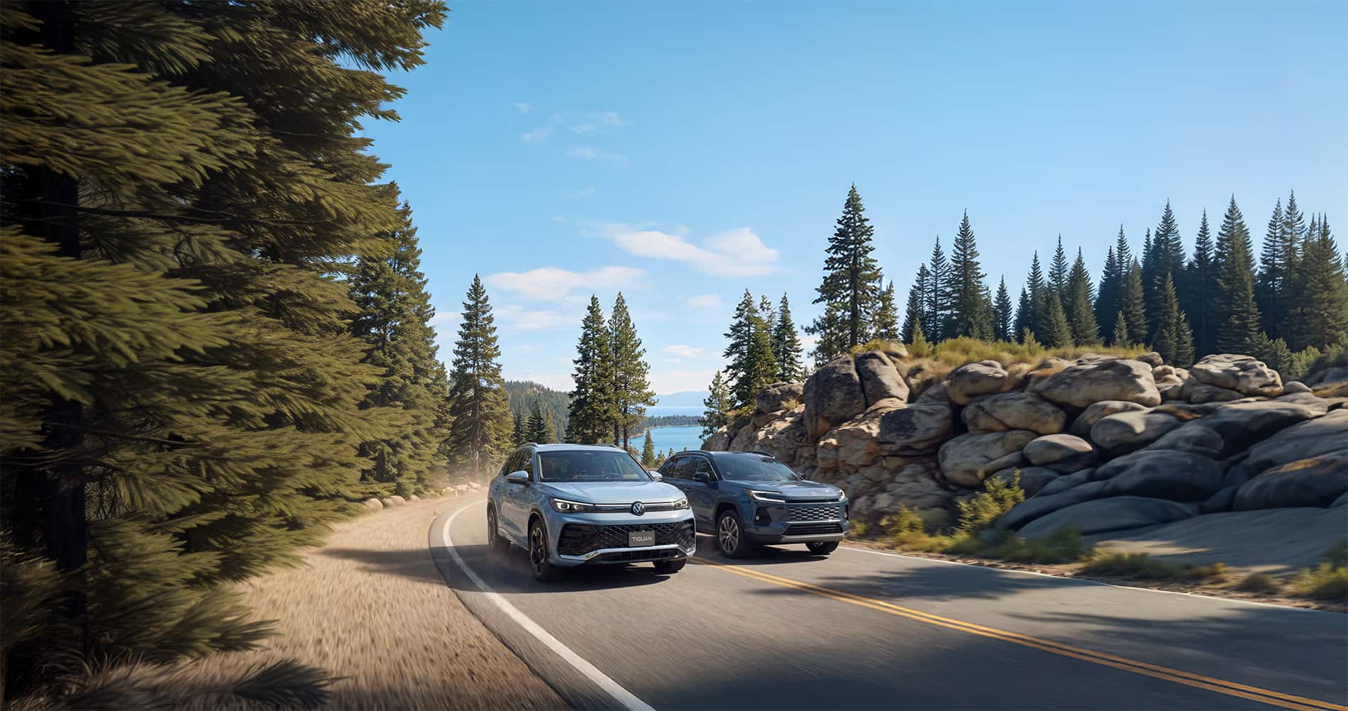 2026 Volkswagen Tiguan vs Toyota RAV4 driving through a forested mountain pass with a lake in the background