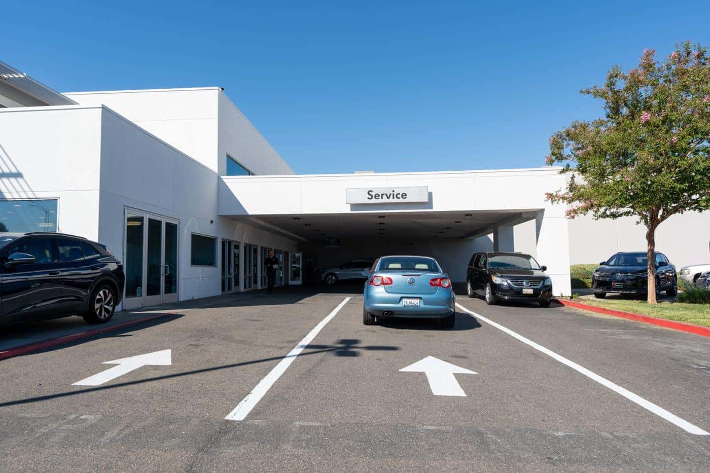 The covered Service drive at Elk Grove Volkswagen with customer cars lined up in the drive lanes
