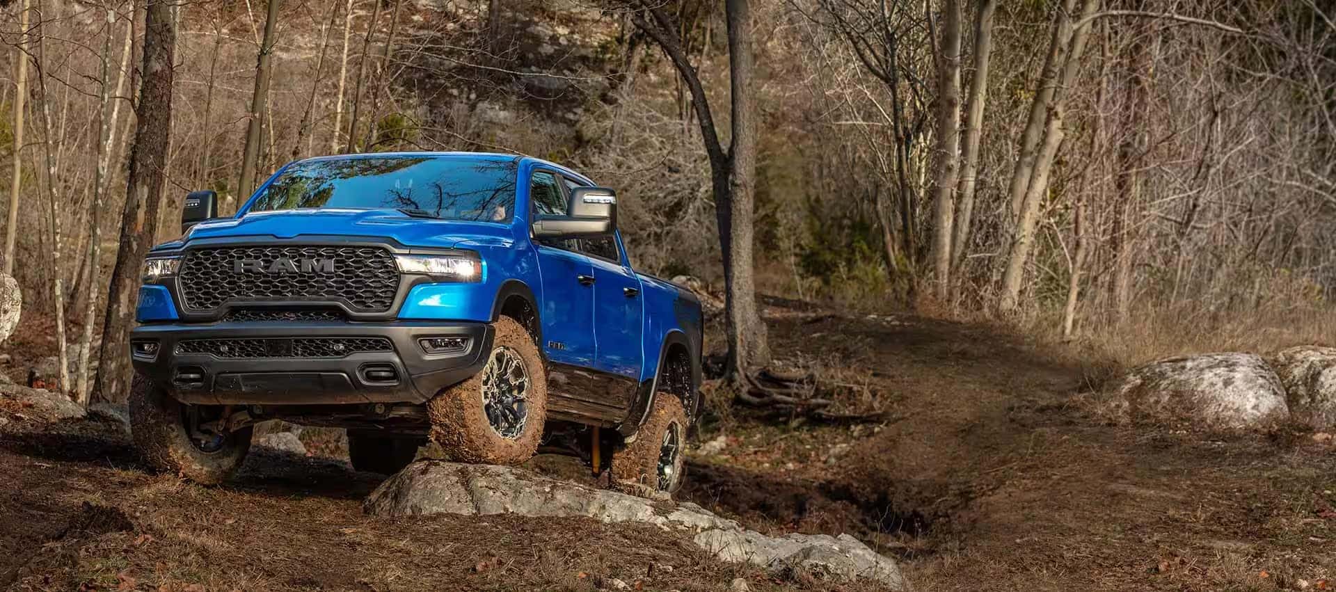Jeep with mud tires splashing through terrain