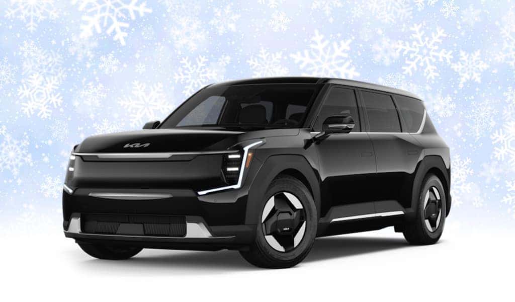 A black Kia EV9 in front of snowflake and light blue background