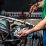 Mechanic near Milwaukee, WI changing the oil in a vehicle