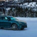 Front exterior view of the 2026 Genesis GV60 driving through snow
