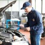 mechanic near milwaukee inspecting under the hood of a vehicle
