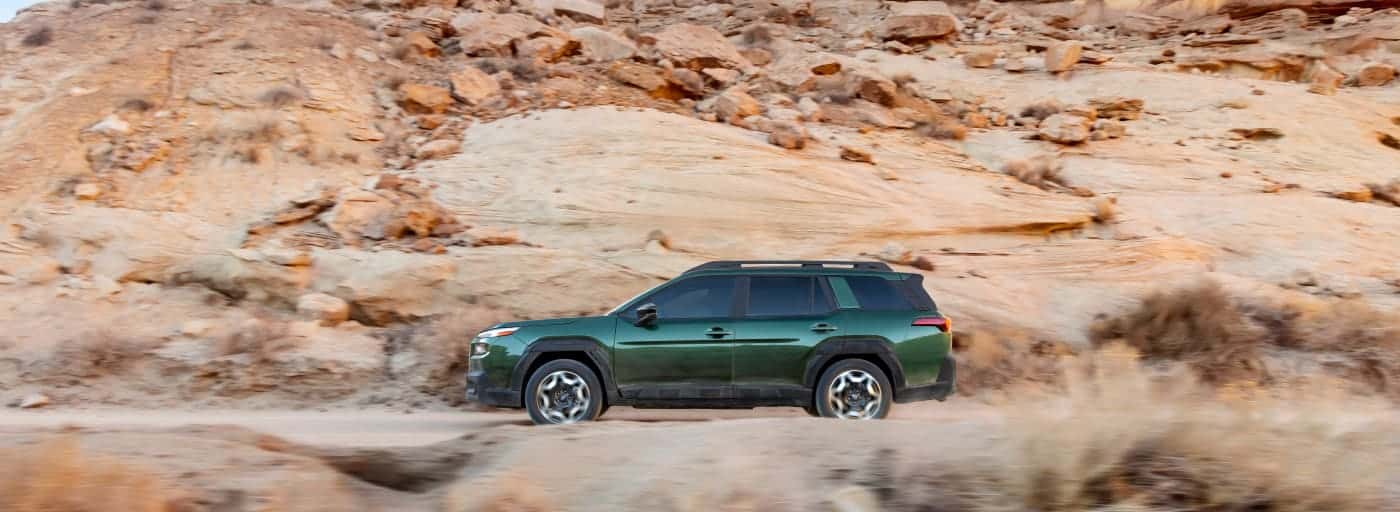 A green 2026 Subaru Outback in Mountains