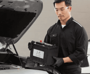 Technician installing Genuine INFINITI OEM parts in Jackson, Mississippi service department