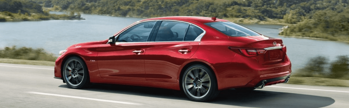2020 Q50 Red Sport on a road next to a lake.