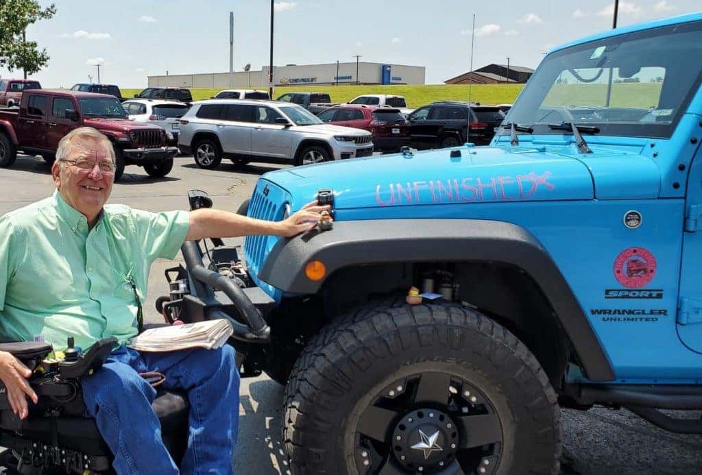 a photo of Bill in front of a blue jeep Wrangler in Guthrie, Oklahoma