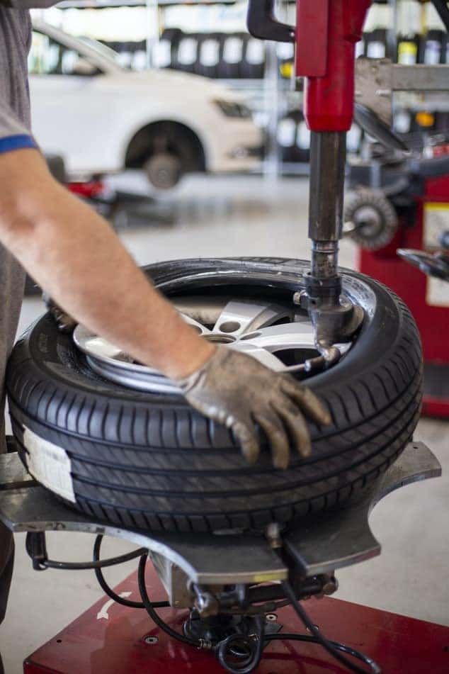 a new tire being put on a wheel at an edmond tire shop