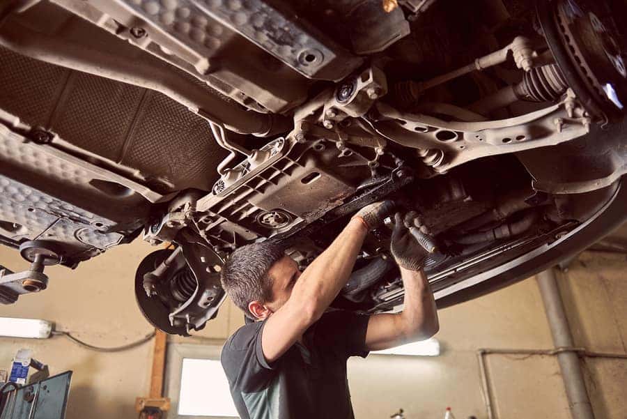 a local mechanic repairing the underside of a car