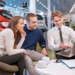 Couple communicating with the salesman in showroom