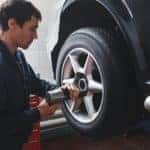 Mechanic changing car wheel in auto repair shop