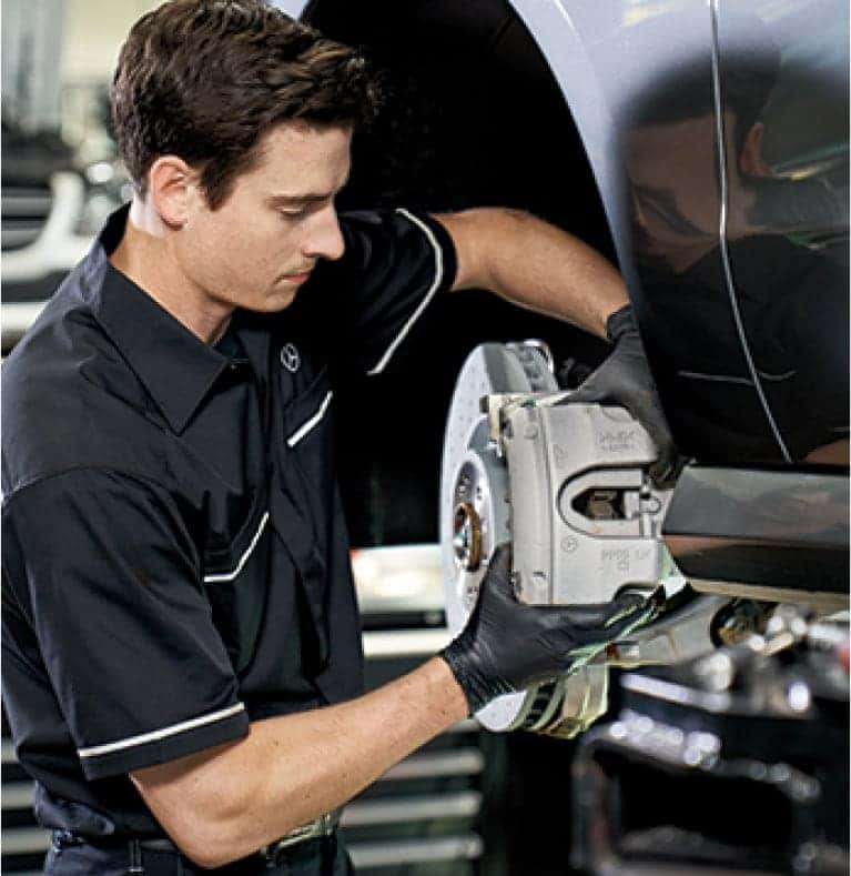 Mercedes-Benz technician working on brakes