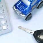 Calculator, toy car, and key representing Mercedes-Benz financing