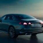 A Mercedes-Benz lease vehicle driving at dusk