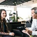 Customer speaking with salesperson at a Mercedes-Benz dealership