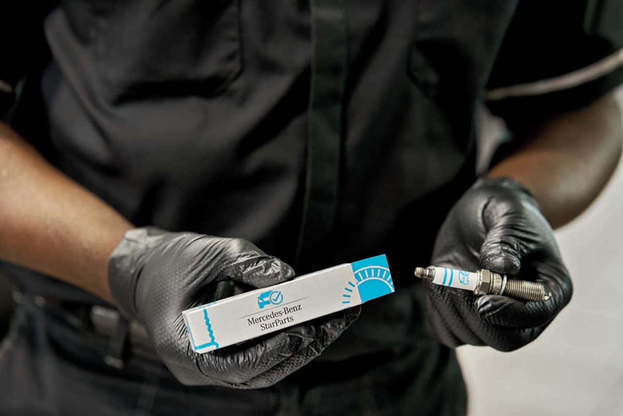 Technician holding new Mercedes-Benz parts