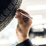 Mercedes-Benz service technician inspecting a tire