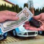 Cash and keys exchanging hands as part of Mercedes-Benz trade-in