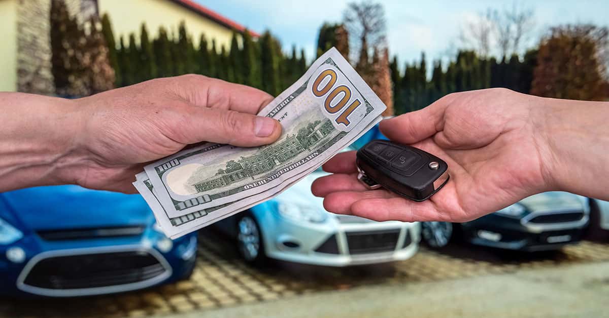 Cash and keys exchanging hands as part of Mercedes-Benz trade-in