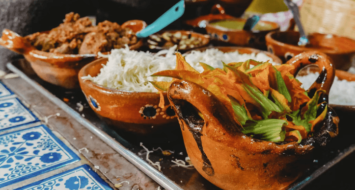 Mexican food served in traditional clay dishes