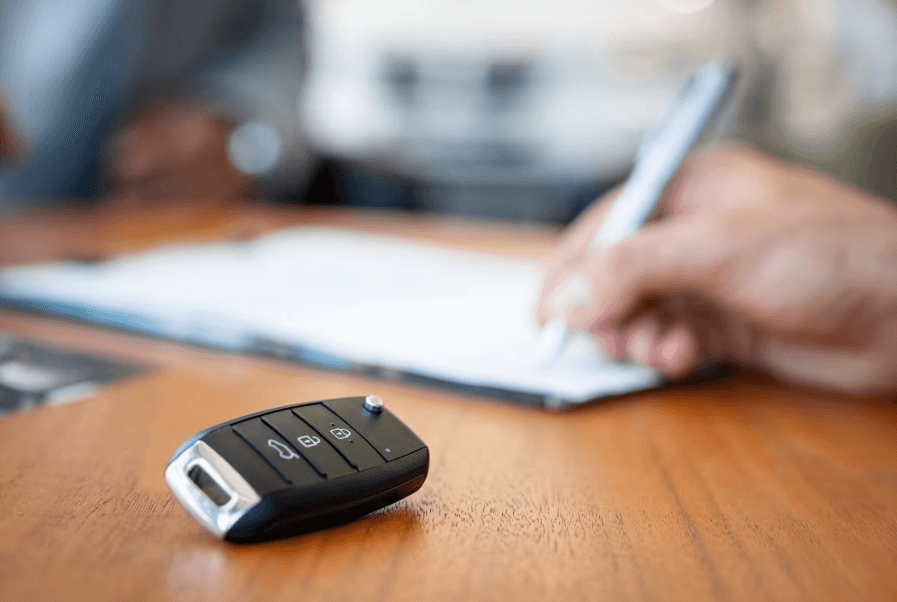Car key on desk during auto financing paperwork
