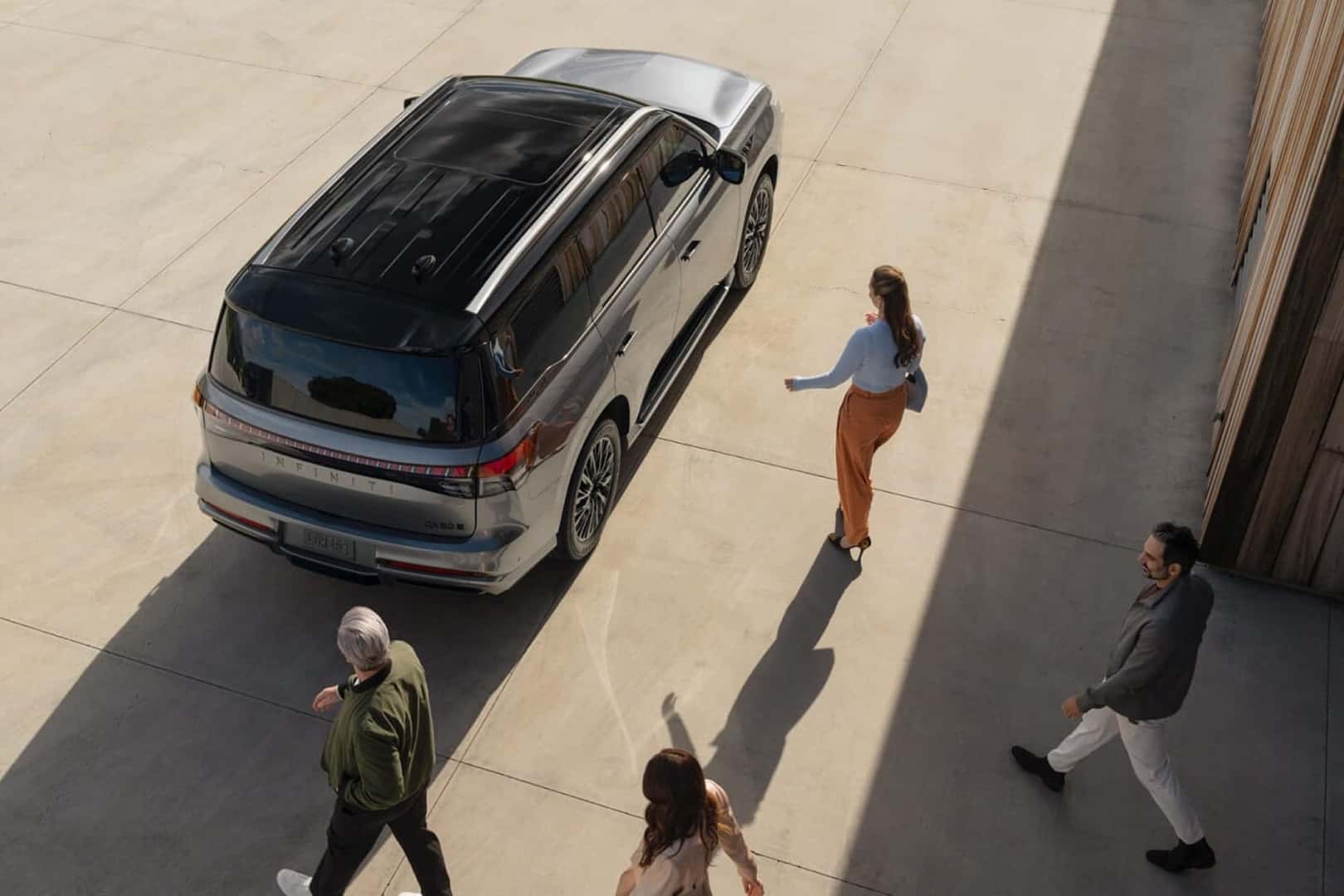 2025 top view of qx80 with people walking to it