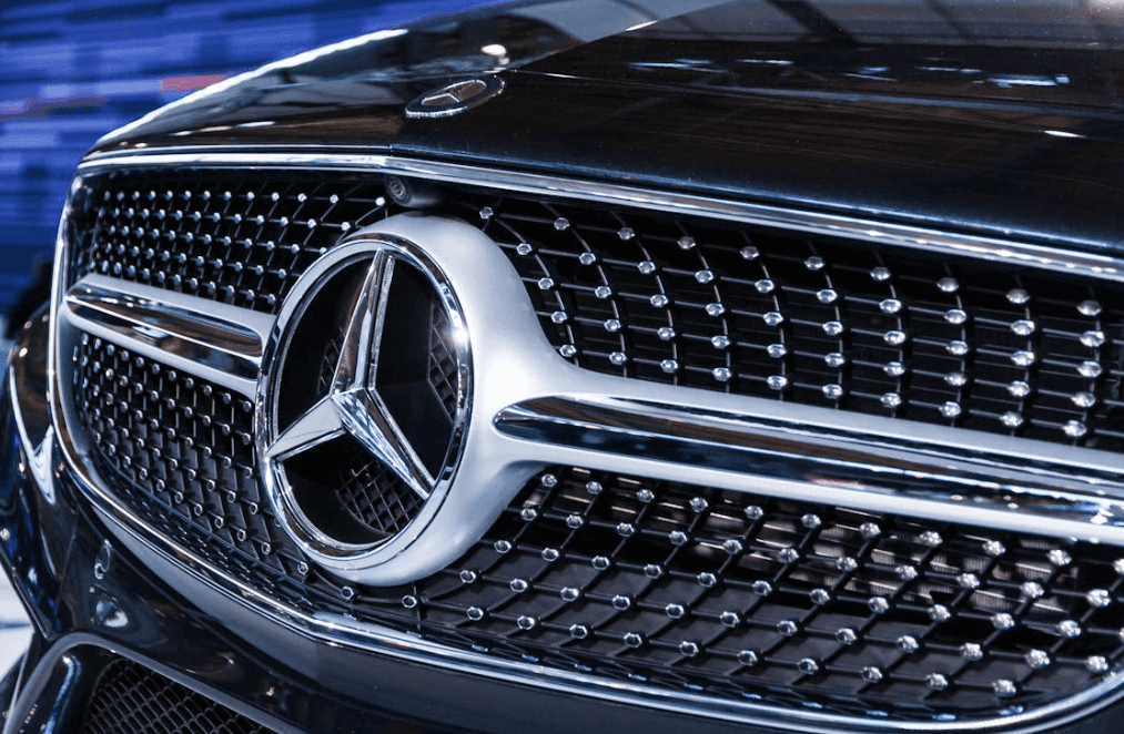Silver grille with large Mercedes-Benz logo on a black vehicle