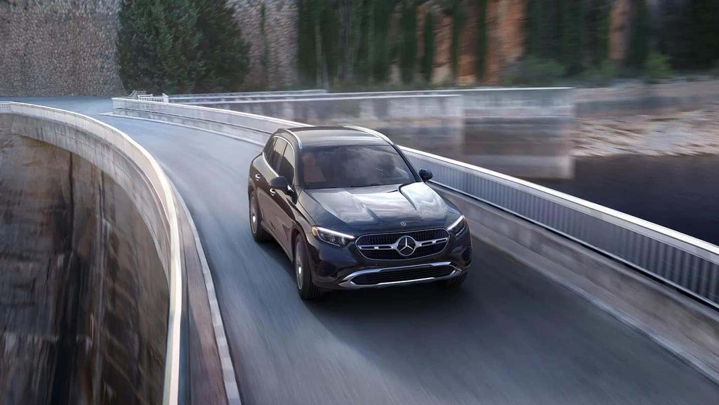 New 2025 Mercedes Benz GLC driving atop of a dam