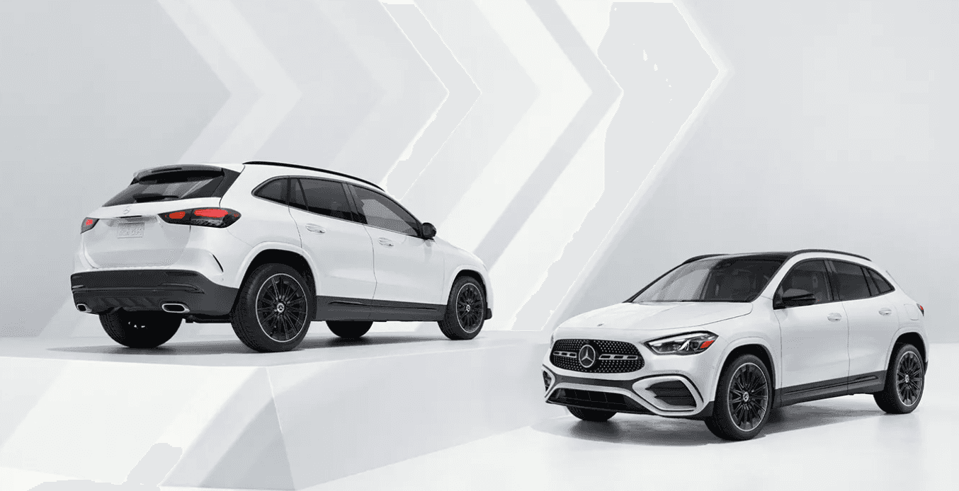 Two white 2024 Mercedes-Benz GLA SUVs parked in a white room. One is parked on a higher platform and its rear is visible