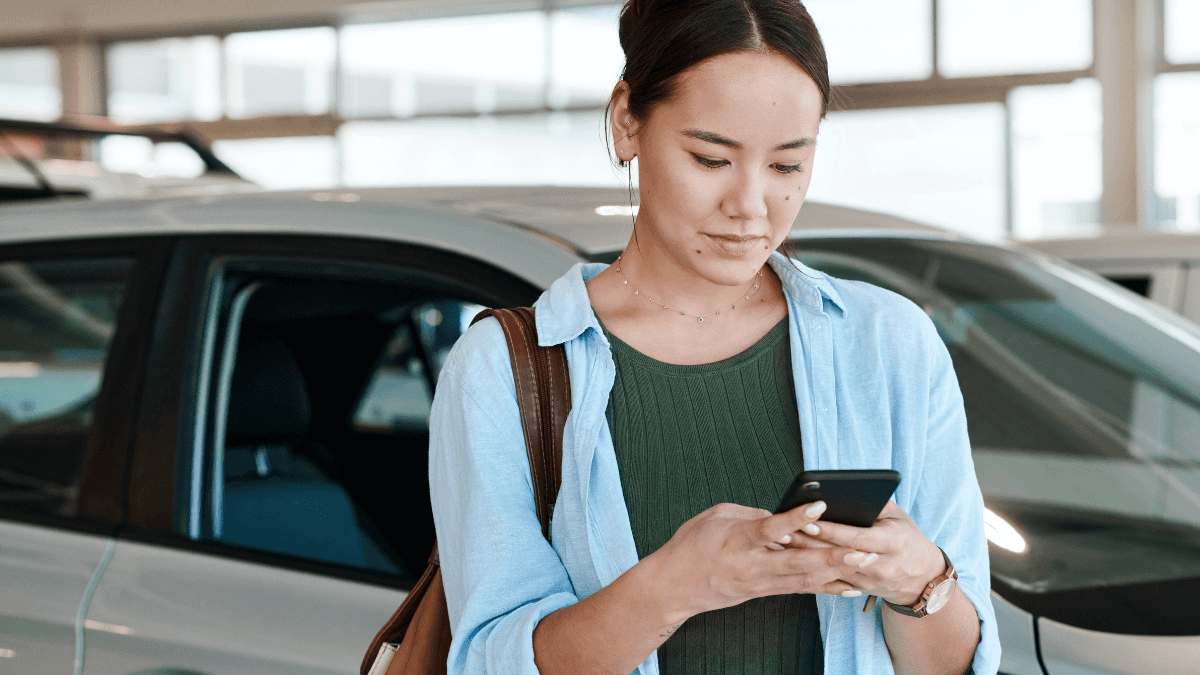 Woman reading the benefits of buying a certified pre-owned