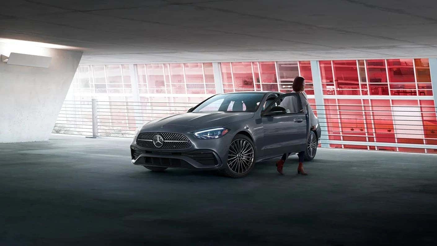 Woman stepping out of a 2025 Mercedes-Benz C-Class