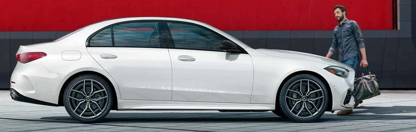 Man approaching his 2025 Mercedes-Benz C-Class sedan