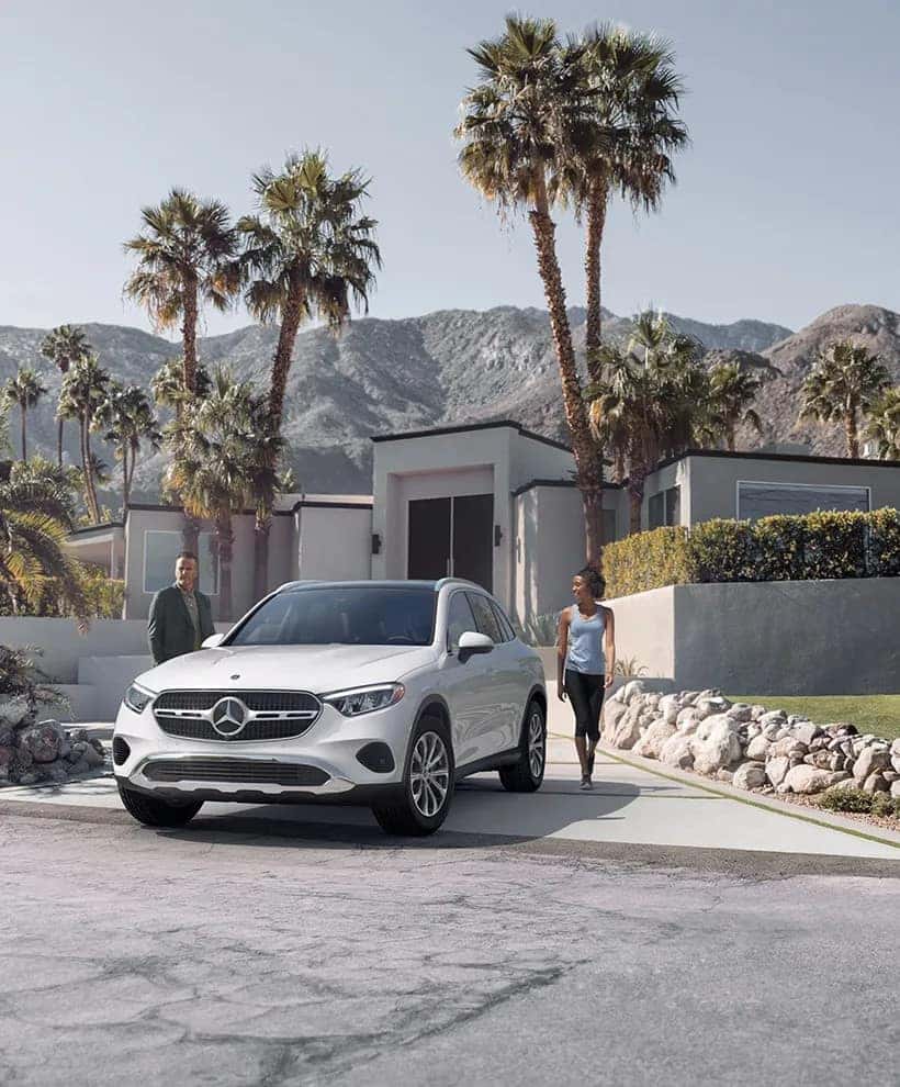 Couple walking out to their 2026 Mercedes-Benz GLC