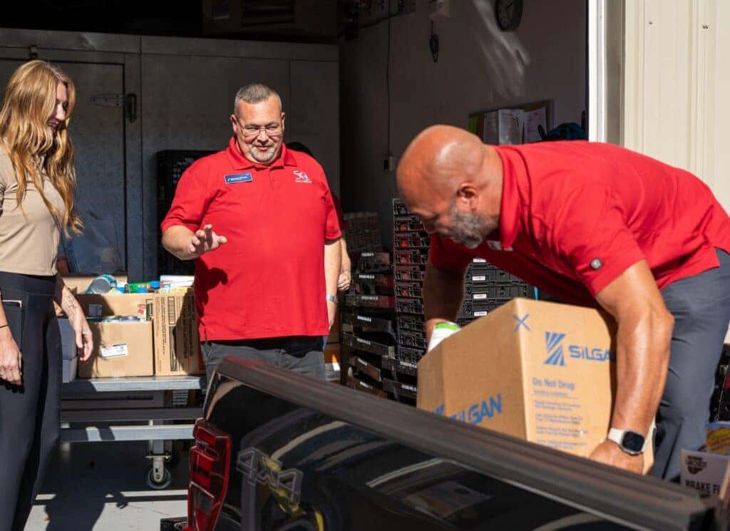 Spencer Grinnell and Sean Turnbull from Quirk Ford Augusta dropping off food to Augusta Food Bank