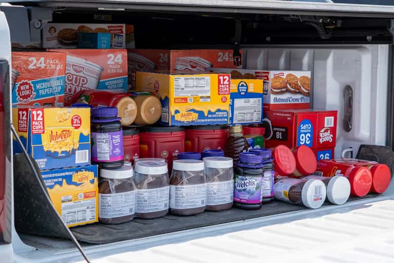 A truck bed packed with donated comfort food including Cup Noodles, mac and cheese, peanut butter, jelly and Oatmeal Creme Pies