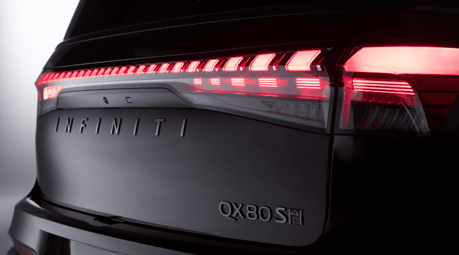 Front-facing view of the 2026 INFINITI QX80 Sport in Obsidian Black featuring the signature illuminated double-arch grille logo and piano-key LED headlights at Ramsey INFINITI in Ramsey, NJ